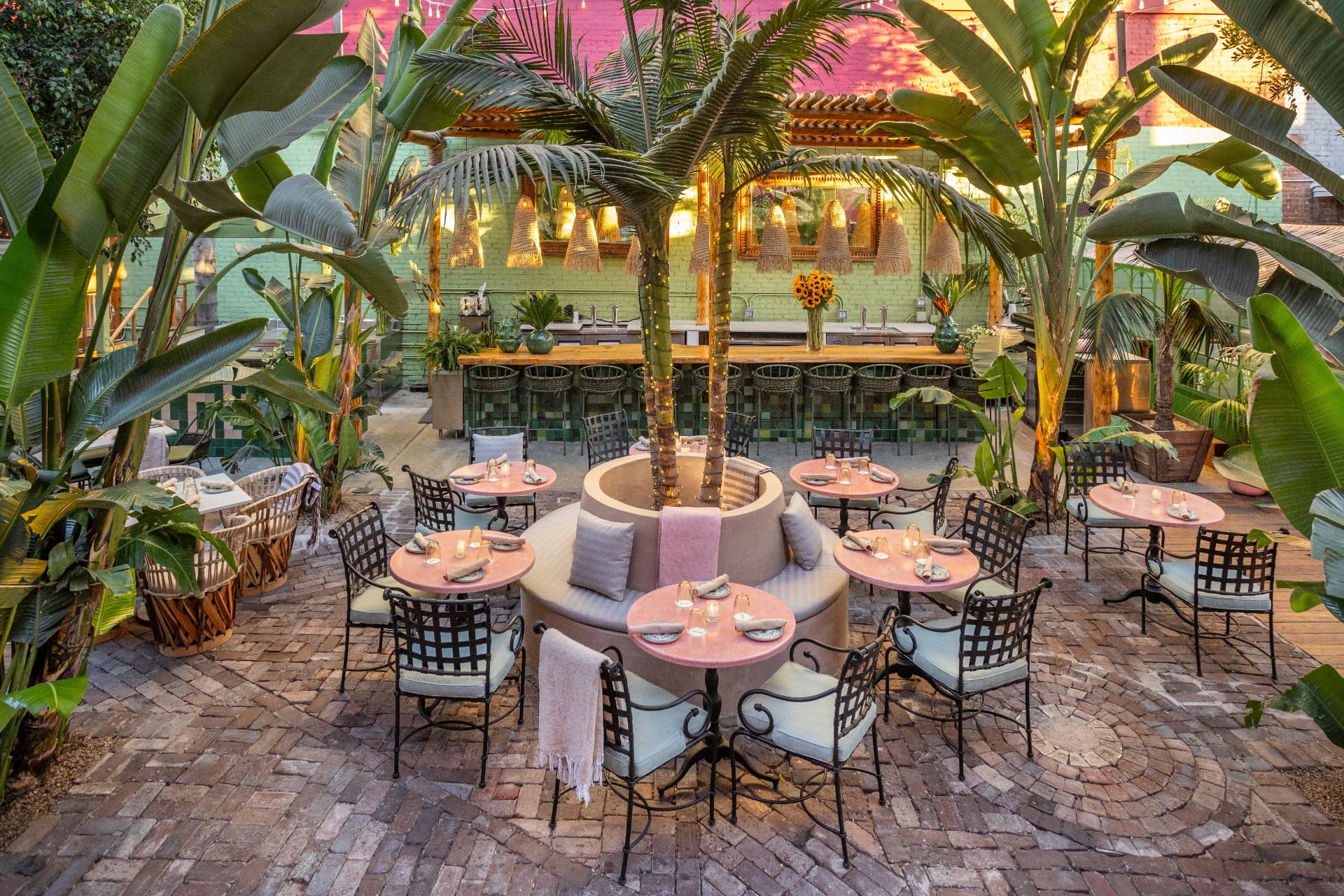 Baja Garden at Tacolina with palm trees, courtyard tables and a tiled bar
