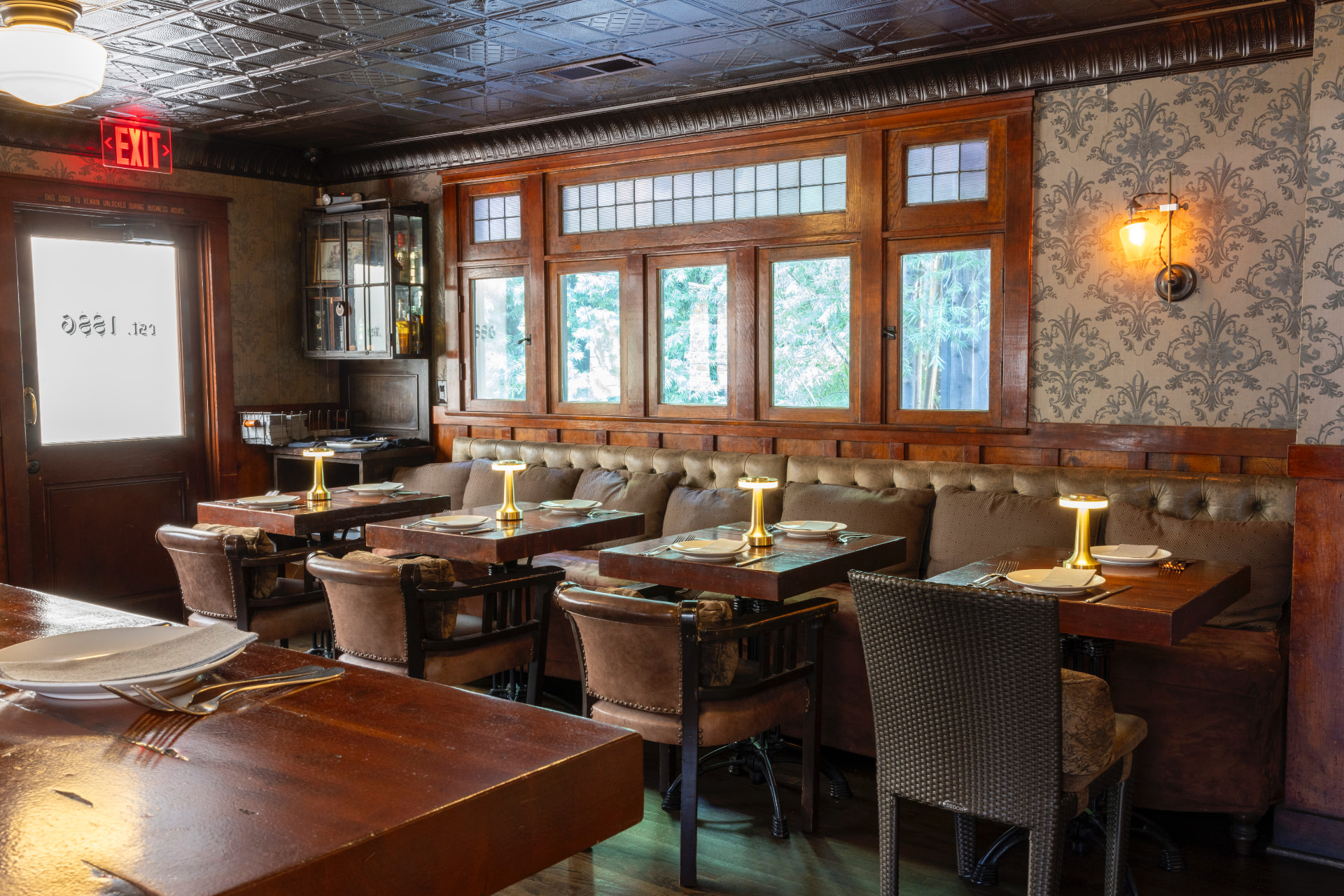 1886 Bar at The Raymond with wood paneling and intimate dining tables