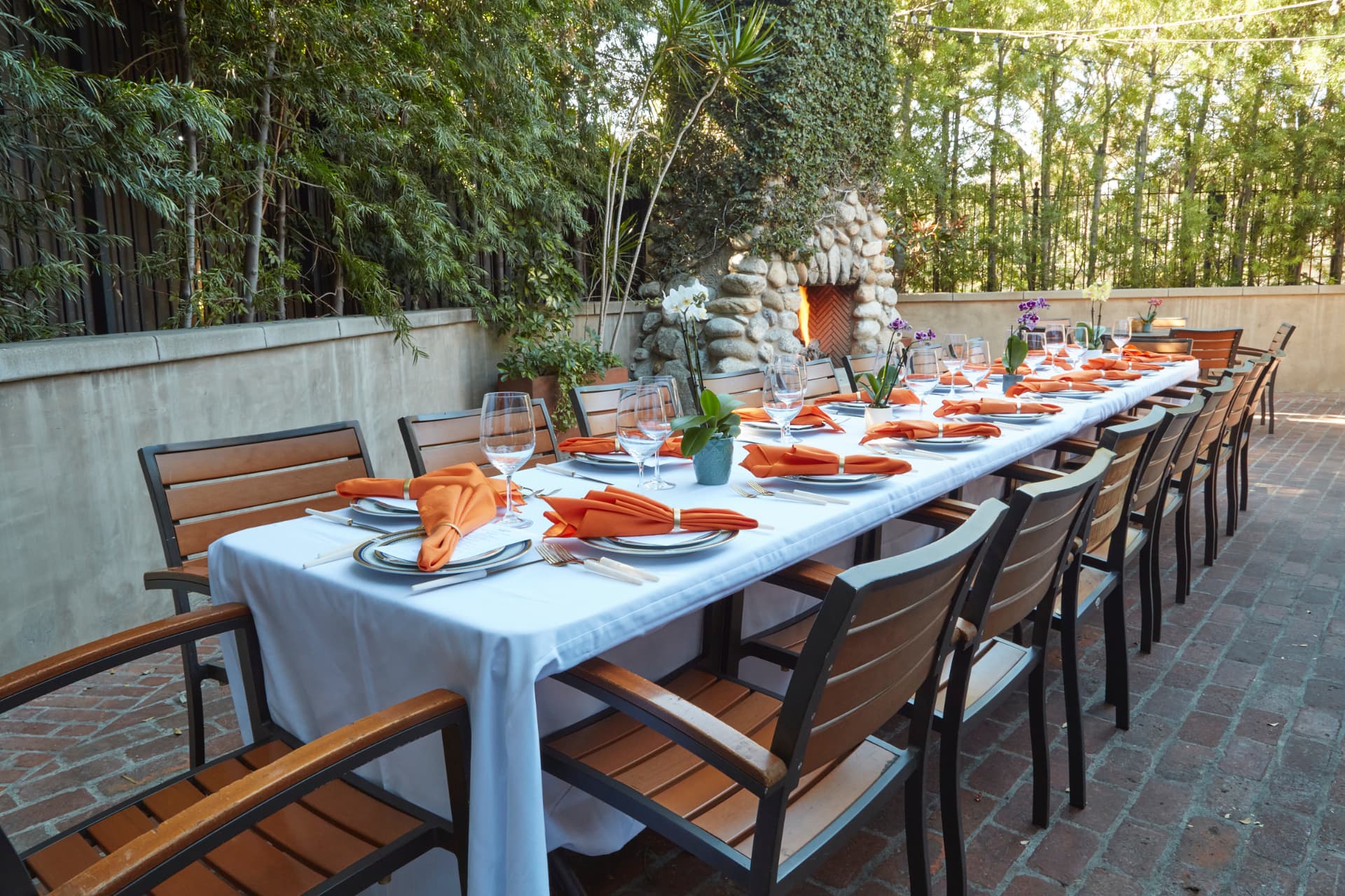 Fireside Terrace at The Raymond 1886 with a stone fireplace and a long dining table