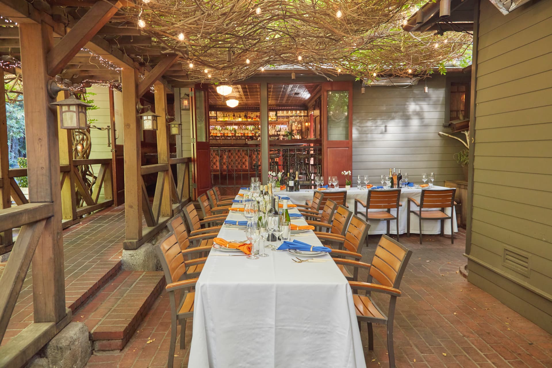 Cactus Garden at The Raymond 1886 with dining tables beneath a leafy canopy